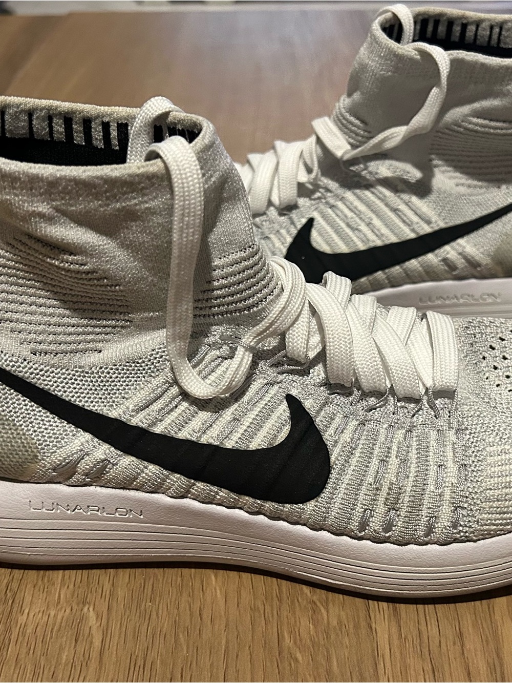 Nike White Flyknit High-Top Sneakers with Black Swoosh